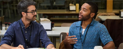 Two professionals discuss retirement MEP transition milestones at a table