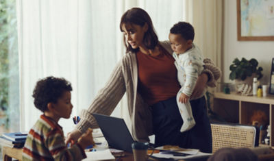 Mother with young children at home discussing education savings plans and funding options for future learning opportunities