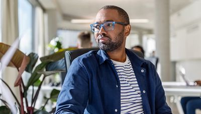 A professor sitting at his desk content