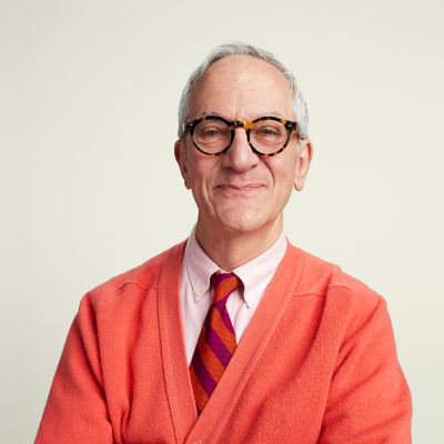 A late career man in a red sweater contemplating retirement.