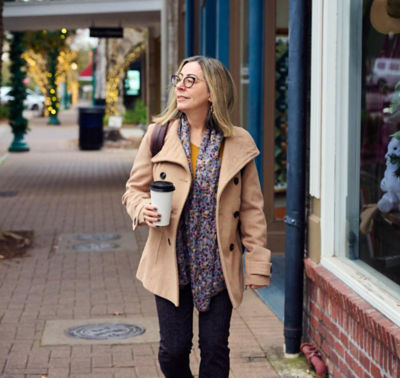 Woman walking along a sidewalk 