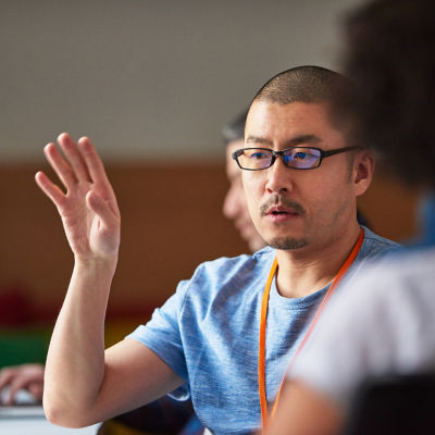 A man is raising his hand to ask a question