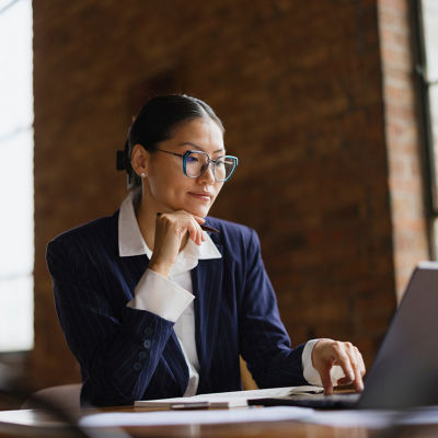 A woman is sitting at a desk working