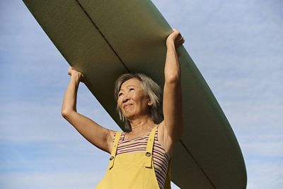 a woman holding a surfboard