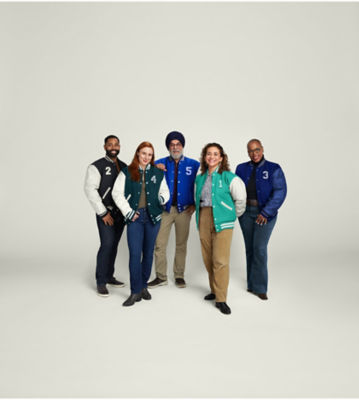 Group of people standing together, each wearing a varsity jacket