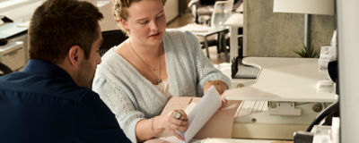 Two people looking through papers