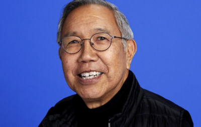 Older man with glasses smiling