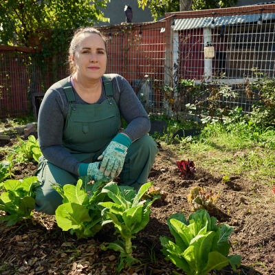 Woman gardening as a metaphor for diversifying investments to grow savings