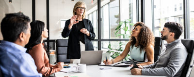 A man gazes intently at a computer screen, focused on the content displayed.