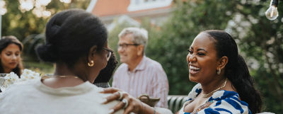 Four family members sitting around a table outside