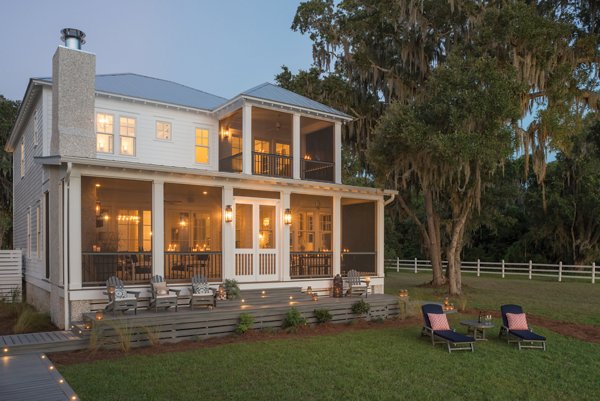 Screened in porch with decking in Trex Foggy Wharf with two Adirondack chairs looking out on the yard