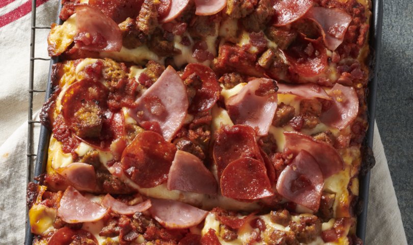pizza toppings on a square dish pizza.