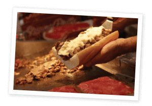 Philly Steak Sandwich being topped with cheese