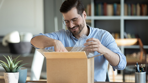 Male pulling out the contents out of an opened package 