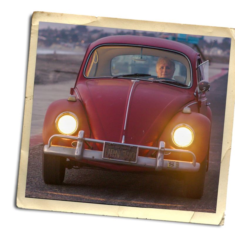 Kathleen Brooks drives her 1967 Volkswagen Beetle towards the camera.