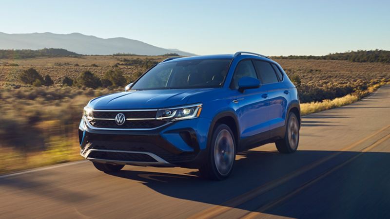 2023 VW Taos in Cornflower Blue, shown from front three-quarters view.