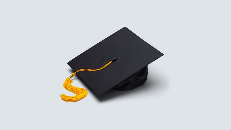 A grad cap with an orange tassel on a white background
