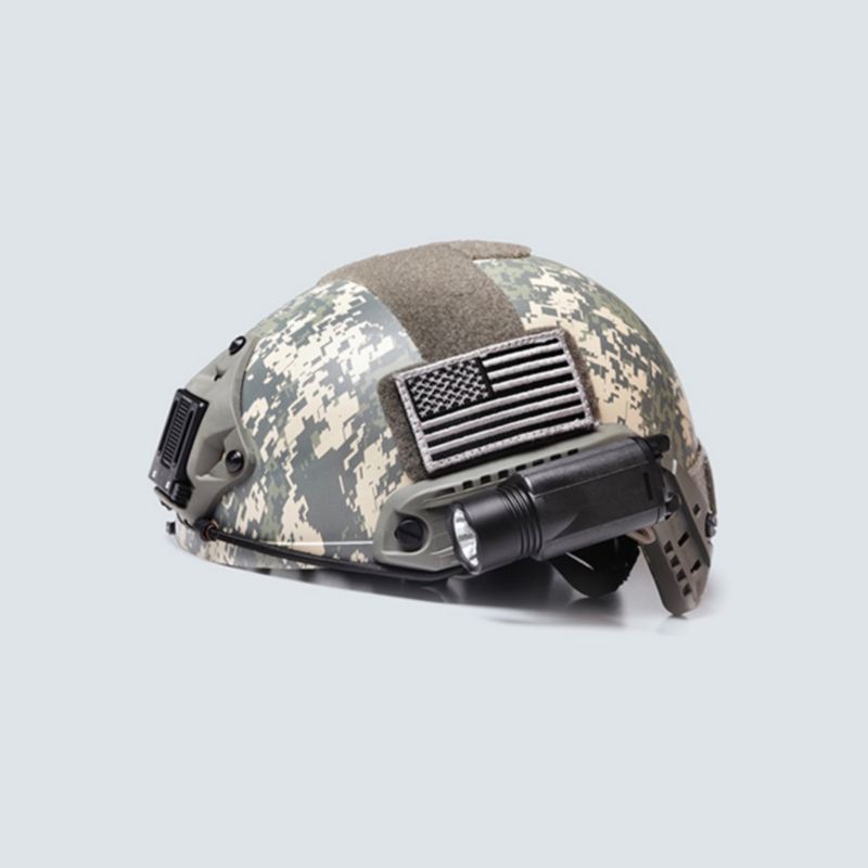 A camo helmet with a flashlight and flag patch