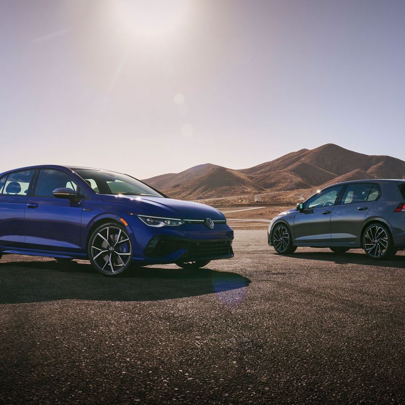 The 2022 Volkswagen Golf R sits on the left of the 2022 Volkswagen Golf GTI.