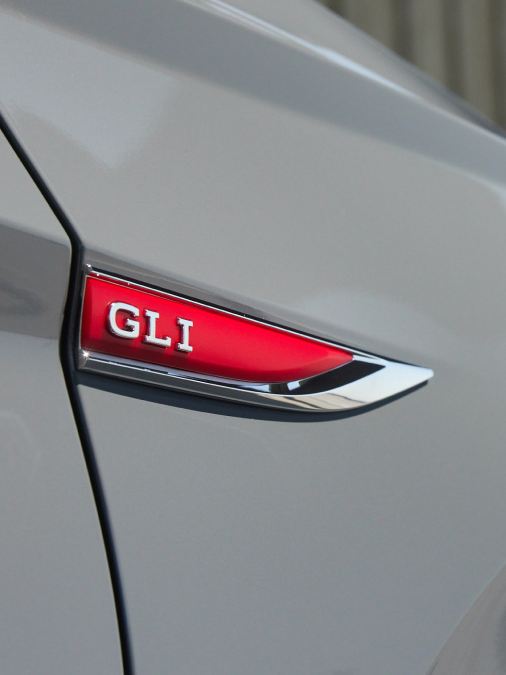 Closeup of GLI badge on right front fender of VW Jetta GLI in Pure Gray. Color adds an additional $395 to price of car.