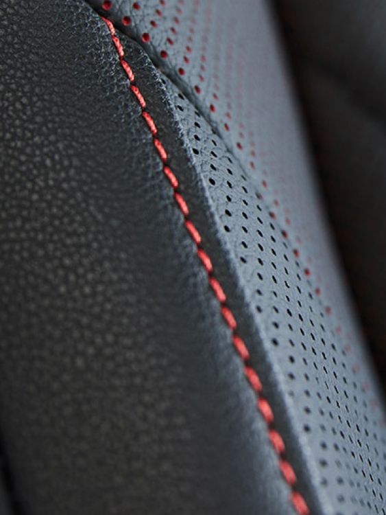 Closeup of red stitching on the door panel of a VW Jetta GLI.