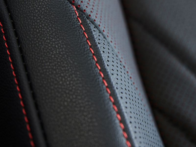 Closeup of red stitching on the door panel of a VW Jetta GLI.