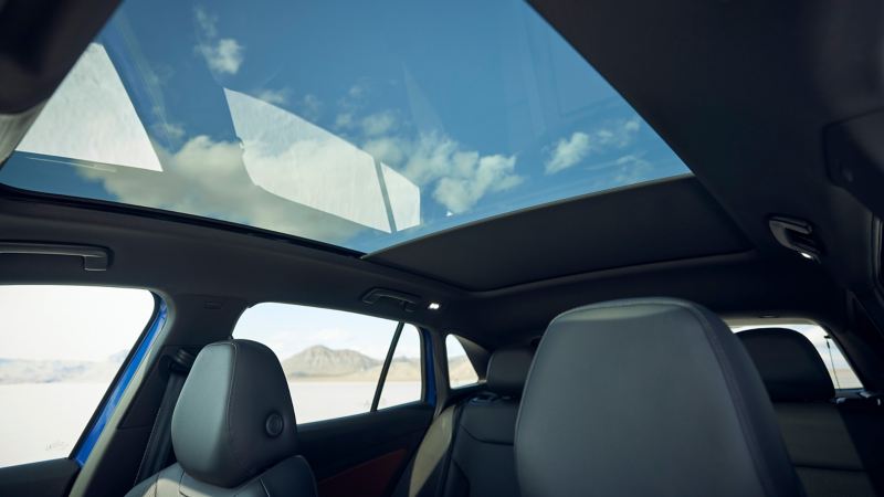 Product shot of 2021 Volkswagen ID.4 panoramic roof over seat tops, with sunshade partially closed.