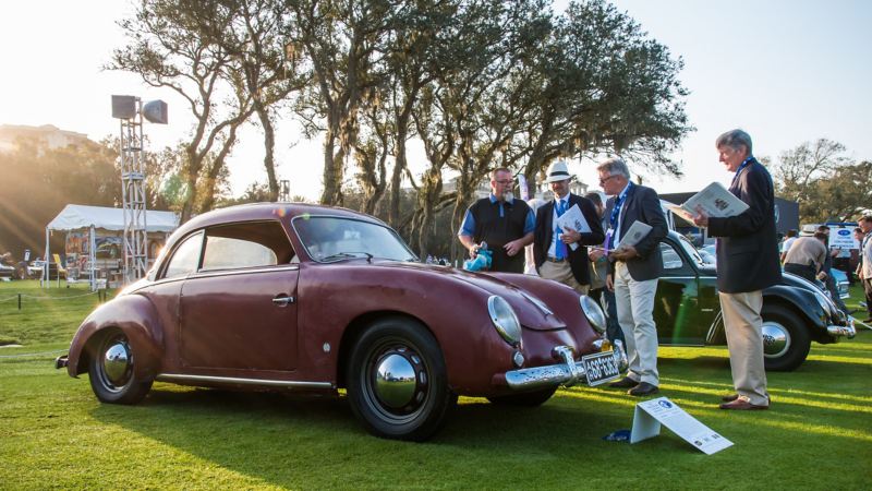 Guests at the 2019 Amelia Island Concours d’ Elegance admire a 1954 Dannenhauer and Stauss coupe. 