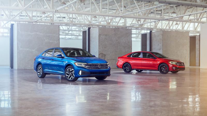 The refreshed 2022 Volkswagen Jetta and Jetta GLI sit side by side in a studio. 