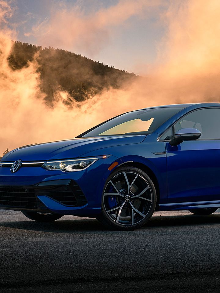 Golf R shown in Lapiz Blue Metallic parked in front of foggy mountains