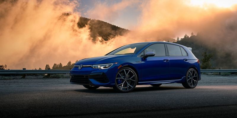 Golf R shown in Lapiz Blue Metallic parked in front of foggy mountains