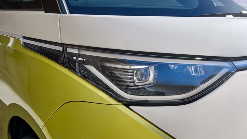A close-up of the passenger side LED headlight on an ID. Buzz in Candy White and Lime Yellow.