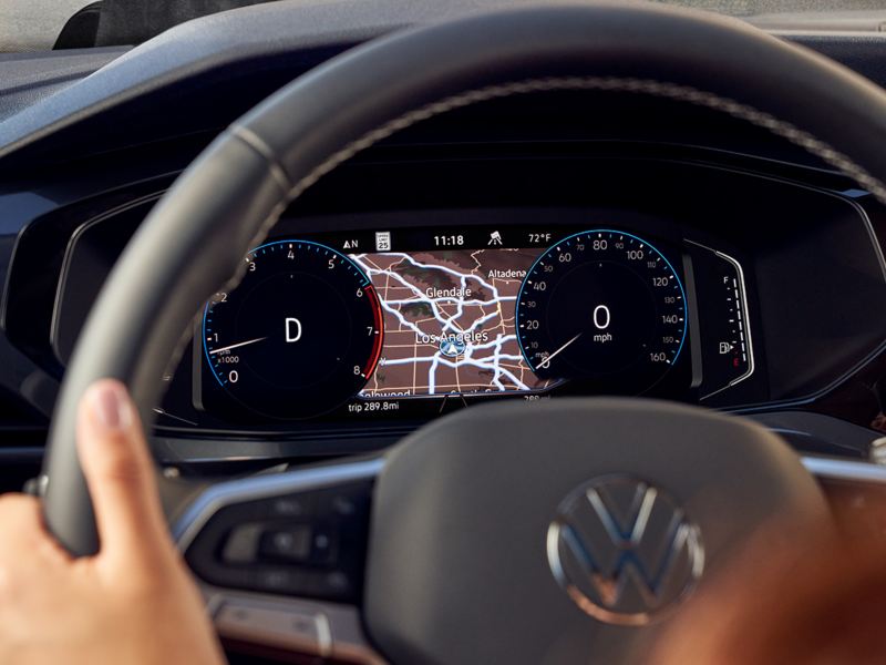 A female driver with her hands on a Taos steering wheel.