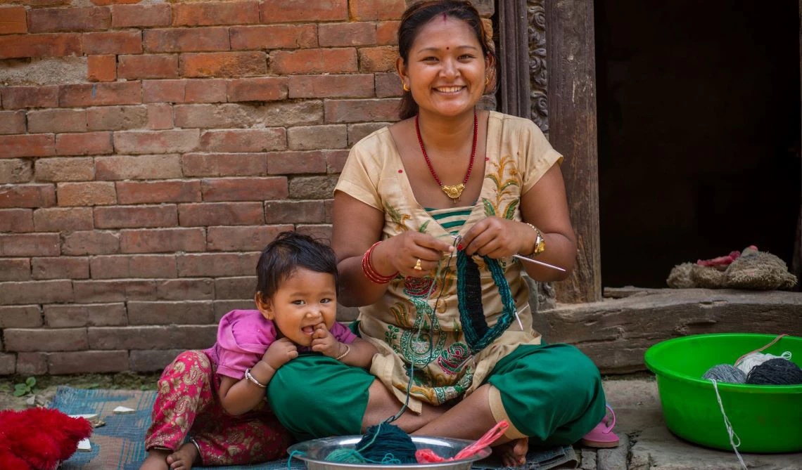 A woman and a child smile to the camera. 