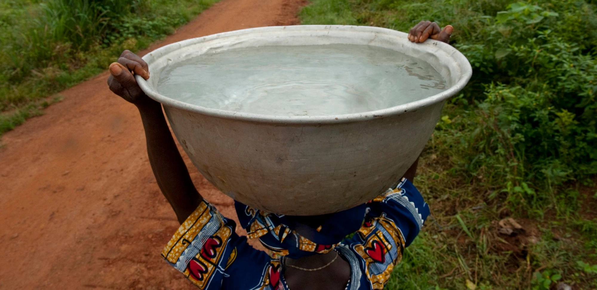 People carrying clean water in Woukpokpoe village. Photo credit: Arne Hoel/World Bank