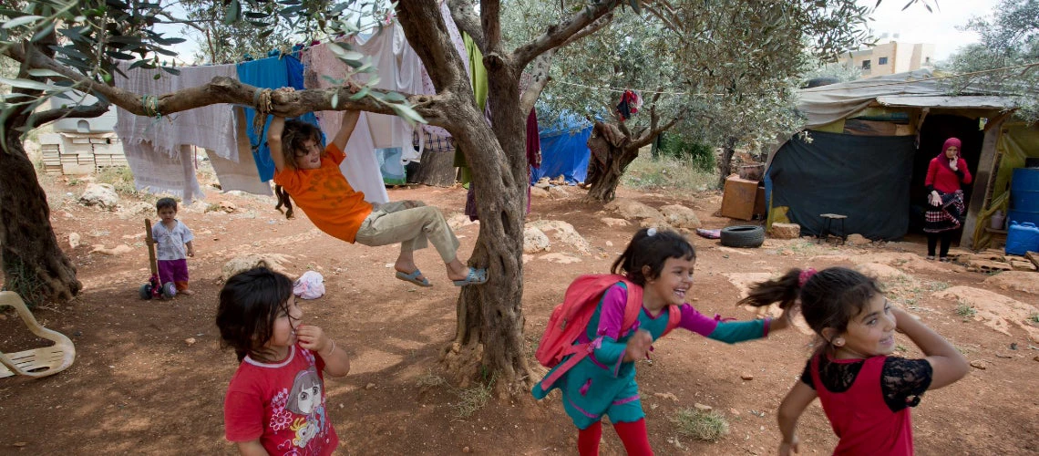 Children playing underneath tree