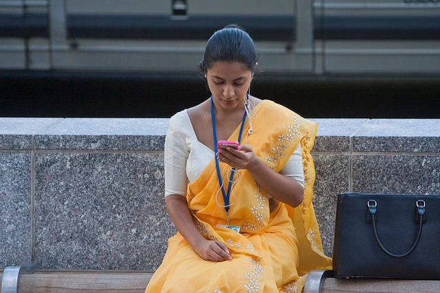 Young woman checks her phone. 