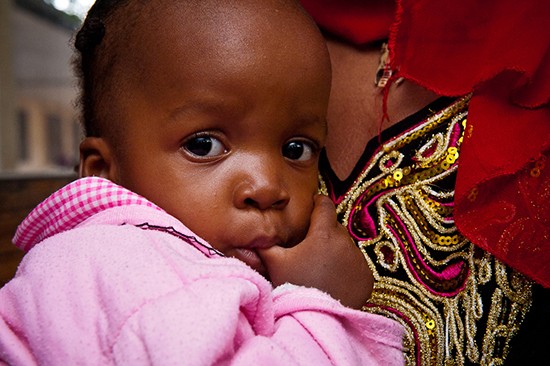 Aina Juma (28) has brought her daughter Maimatha (two year) to the Magomeni Health Center because she has been vomiting and running a fever. Tests are taken and she will return the next day with a urine sample and learn of the results. Dar es Salaam, Tanzania. (Photo: Arne Hoel)