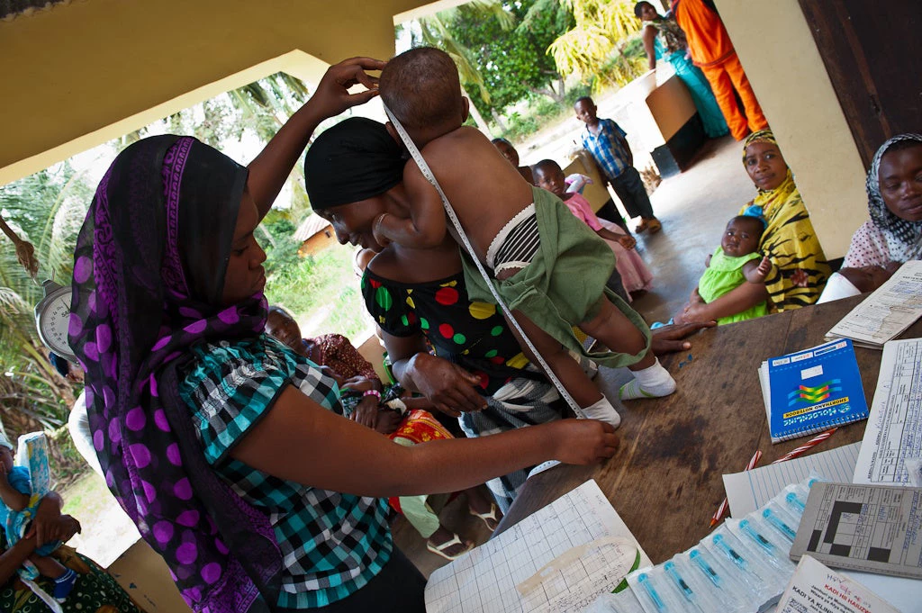 Examen de santé des jeunes enfants au dispensaire du village de Kiwanga, à une quarantaine de kilomètres de Bagamoyo (Tanzanie). Ce centre de santé primaire dessert environ 20 000 habitants des environs. © Arne Hoel/Banque mondiale