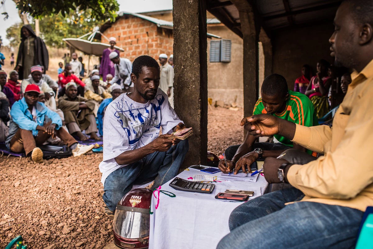 Hafia village, prefecture of Dalaba, Guinea. A man receive money as part of a social net project. © Vincent Tremeau /World Bank