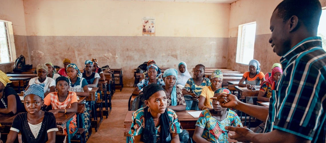 Teacher in a class in front of students