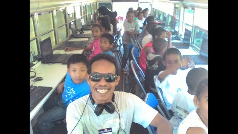 Malagasy children learning coding basics on the CoderBus, a mobile computer lab that brings computer science to children throughout the country.