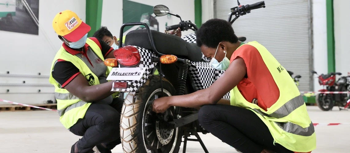 Mechanics repairing a motorcycle