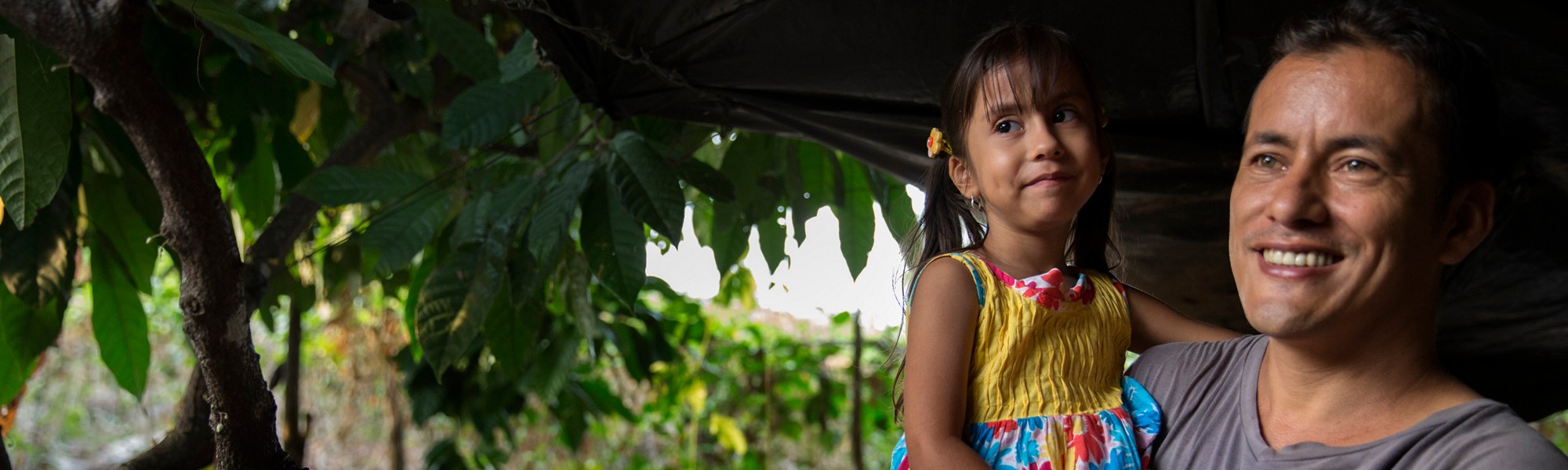 Yamid Duran Ramirez holds his daughter Leyla Duran Vergora after working on his farm where he grows passion fruit, in the township of La Paz, Colombia on January 12, 2015. Photo © Dominic Chavez/World Bank



