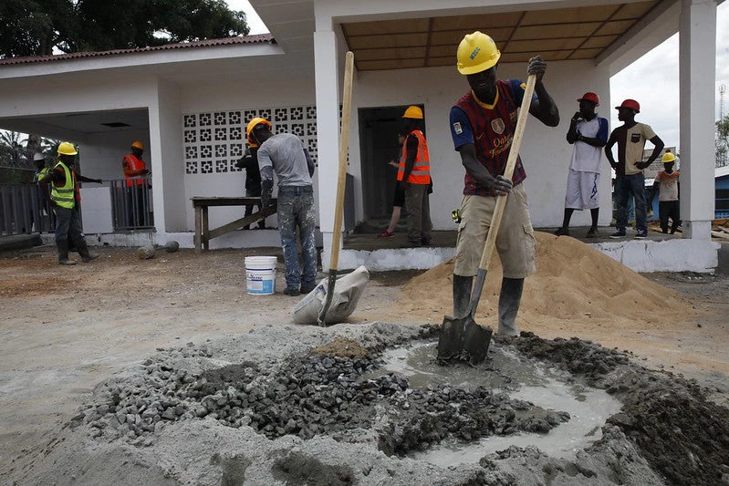 Construction workers build a new triage and water tank system