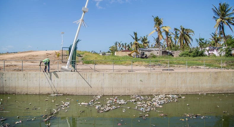 Municipal worker cleans canals that reduce the risk of flooding in Beira