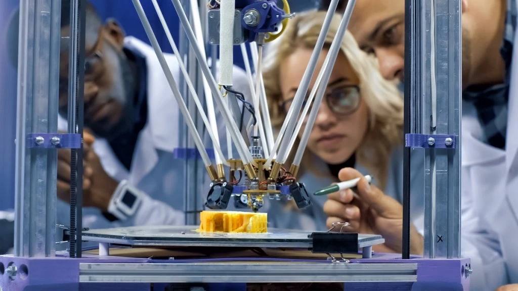 Scientists working with a 3D printer. Photo: FrameStockFootages/Shutterstock