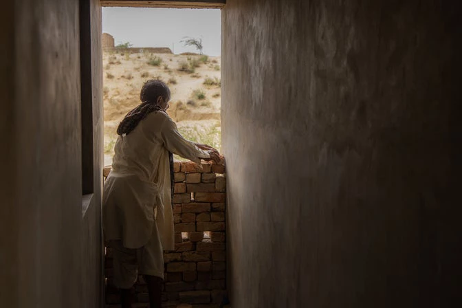 Sono Mal from Thar, beneficiary of the Pakistan Housing Finance Project, overseeing the construction of his new home