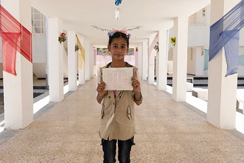 Student stands in the hallways of the newly opened school.