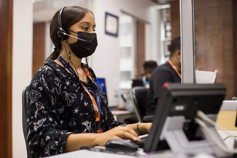 A woman works in front of a computer in the call center of the main offices of Edesur (Electricity distribution company), in the Customer Service area of the country's electrical network, on June 25, 2021 in Santo Domingo, Dominican Republic
